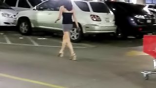 Intriguing babe is recorded while she walks to her car after shopping in a box store.